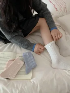 Korean style solid color cable knit mid-tube women socks with cute shell button, casual autumn wear.