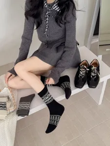 Detailed shot of Korean style Fair Isle grey mid-tube socks, vintage knit pattern for women.