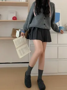 Close-up detail of dark grey ribbed mid-tube socks paired with casual daily outfit.