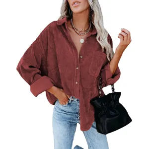 Close-up detail of women's corduroy button-down shirt jacket in burgundy with chest pocket.