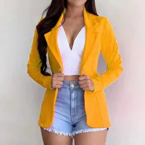 Detailed view of the stylish yellow women's blazer featuring a classic lapel and slim long sleeves.
