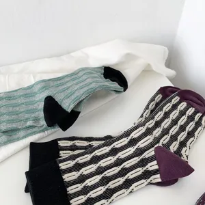 Detailed view of women autumn winter colorblock cable knit mid tube socks retro style.