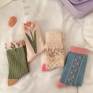 Close-up detail of cute floral and tulip pattern cotton mid-calf socks in retro style.