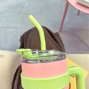 Close-up detail of 40oz insulated tumbler with straw and handle, pink and green design.