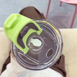 Detail view of the 40oz tumbler replacement lid with clear rotating cover and green straw tab.