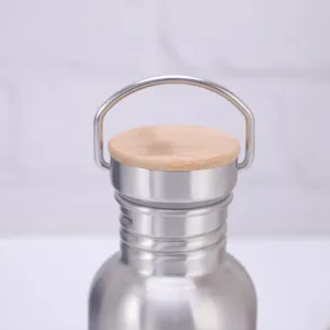 Close-up detail shot of stainless steel water bottle with eco-friendly bamboo lid handle.