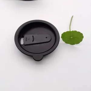 Detailed close-up view of the black plastic cup lid with sliding opening mechanism.