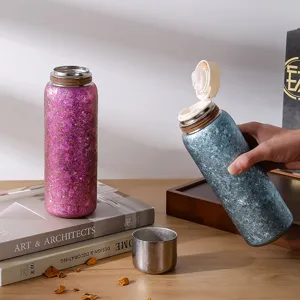 Vue détaillée de la bouteille isotherme en pur titane avec texture étincelante et bouchon.