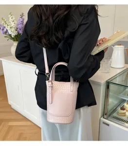 Korean style pink woven bucket bag for women, chic shoulder handbag detail showcase.