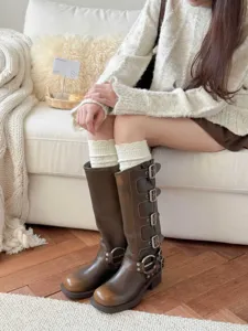 Retro multi-buckle tall boots paired with cozy knit stockings, perfect for autumn winter styling.