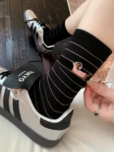 Black striped mid-calf socks featuring a cute embroidered dachshund dog design. Comfortable cotton.