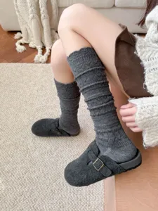 Detail view of retro gray hollow-out knit slouch socks, warm long tube design for autumn.