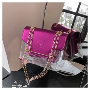 Detail view of stylish clear PVC shoulder bag with metallic purple flap and gold chain strap.