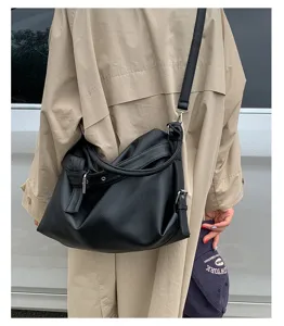 Casual black leather slouchy shoulder bag detail, stylish motorcycle crossbody bag for daily commute.