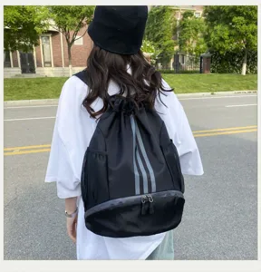 Detailansicht des schwarzen Kordelzug-Rucksacks mit drei Reflektorstreifen und Netztaschen.