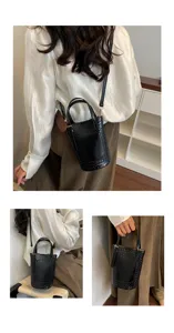 Black woven bucket bag detail showing premium texture, shoulder strap and metal hardware.
