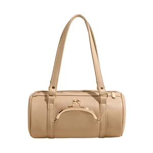 Chic beige litchi grain cylindrical shoulder bag with kiss-lock closure and elegant dual straps.