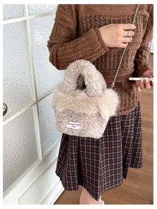 Plush handbag detail shot featuring soft fuzzy material and stylish metal chain strap.