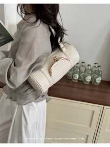Vintage cylindrical shoulder bag for women, elegant kiss-lock PU leather handbag, chic style.