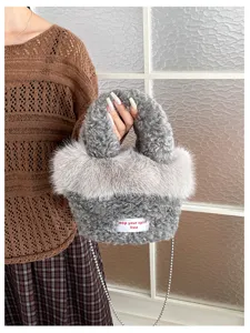 Grey fuzzy plush handbag with chic fur trim, metal chain strap and cute decorative tag.