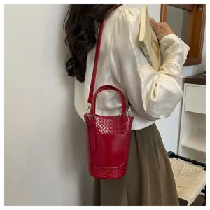 Red woven bucket bag for women, stylish single shoulder handbag with top handle design.