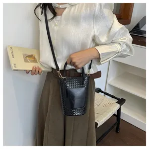 Stylish black woven bucket bag for women, versatile shoulder handbag with chic design.