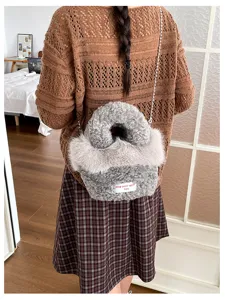 Chic fuzzy crossbody bag for women, trendy fluffy plush handbag with stylish chain strap.