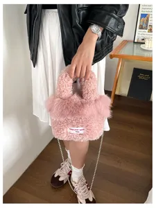 Chic pink plush fluffy handbag for women, versatile crossbody shoulder bag with chain strap.