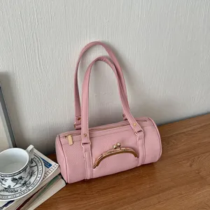 Pink cylindrical shoulder bag for women, stylish faux leather handbag with kiss lock.
