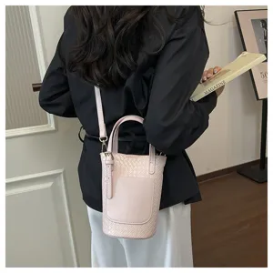 Detailed view of the pink woven bucket bag, featuring stylish texture and dual straps.