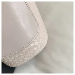 Detail shot showcasing premium woven leather texture of the elegant women's single shoulder bucket bag.