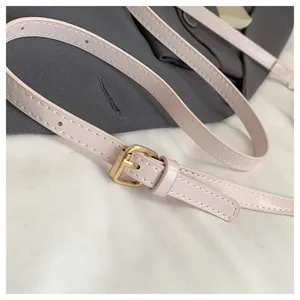 Shoulder bag strap detail, pink PU leather with gold metal buckle, exquisite craftsmanship.
