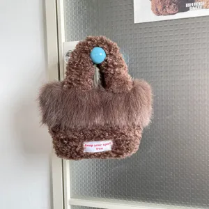 Fluffy faux fur crossbody bag for women, cozy brown shoulder handbag with chic fuzzy texture.