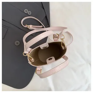 Detailed top view of the pink leather bucket bag interior and metal hardware components.