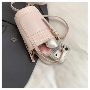 Pink woven bucket shoulder bag for women, stylish crossbody purse with large capacity.