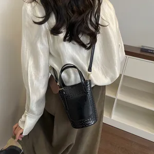 Black woven bucket bag for women, stylish leather shoulder bag with top handle and great quality.