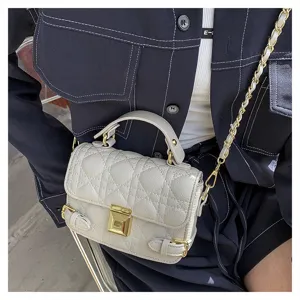 Elegant quilted mini shoulder bag detail, premium leather texture with gold chain strap.