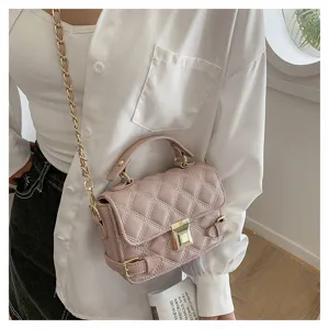 Elegant pink quilted crossbody shoulder bag with gold chain strap and top handle for women.