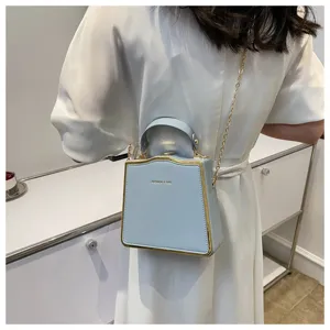 Light blue top handle box bag with elegant gold trim and metal chain strap for women.
