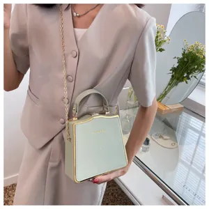 Stylish light green structured box bag with gold chain and metal trim, perfect for daily wear.