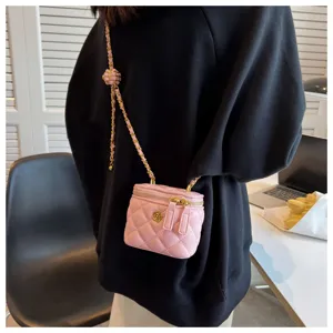Quilted chain box bag detail, mini pink shoulder bag with elegant metal strap and floral clasp.