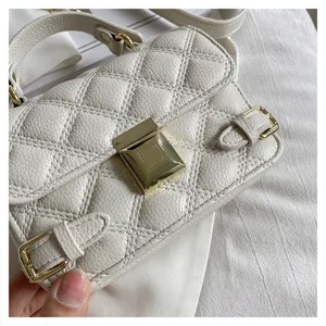 White quilted women crossbody bag detail view, classic leather small shoulder handbag.