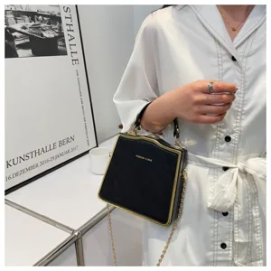 Stylish black structured box handbag with gold trim and chain strap for modern women fashion.