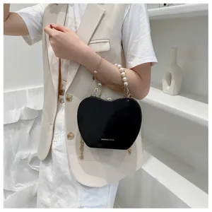 Women stylish black heart-shaped crossbody bag with elegant pearl handle and metal chain strap.