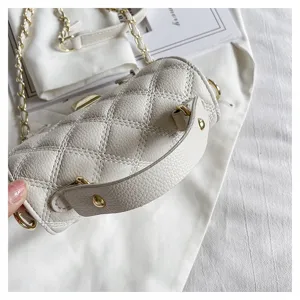 Elegant white quilted leather crossbody bag with gold chain strap and top handle for women.