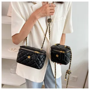 Quilted chain vanity bag detailed view, black PU leather crossbody bag with chic flower emblem.