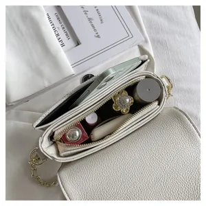 White quilted chain crossbody bag detail, elegant small shoulder bag with inner capacity.