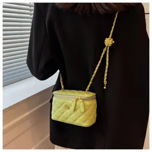 Quilted chain vanity shoulder bag detail, stylish women crossbody handbag with flower decor.