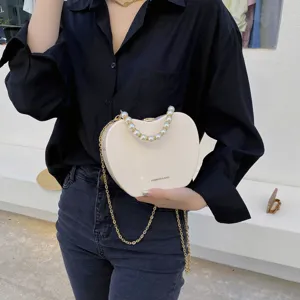 Stylish pearl handle crossbody bag for women, chic heart shaped shoulder chain bag daily use.