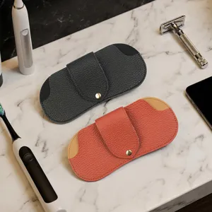 Leather glasses case detail shot showing texture, snap button, and daily use scene setup.